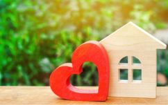 Wooden Heart Cut Out Next To Wooden Home Cut Out