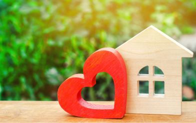 Wooden Heart Cut Out Next To Wooden Home Cut Out